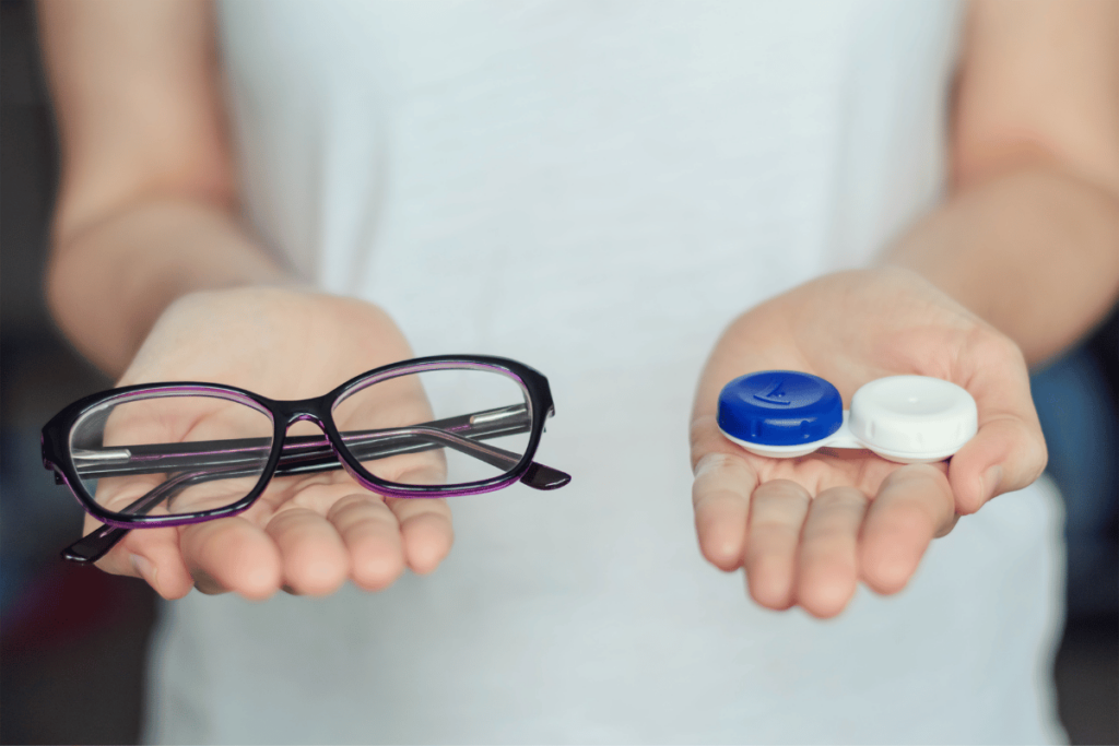 a woman holding a pair of glasses and a contact lens case in her hands