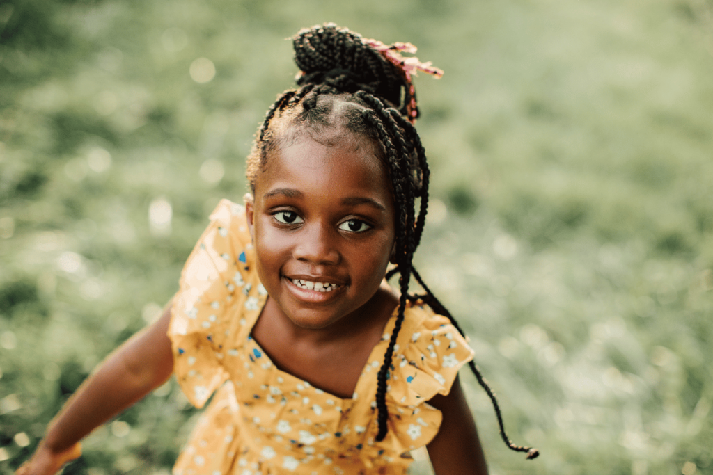 a little girl smiling and looking up