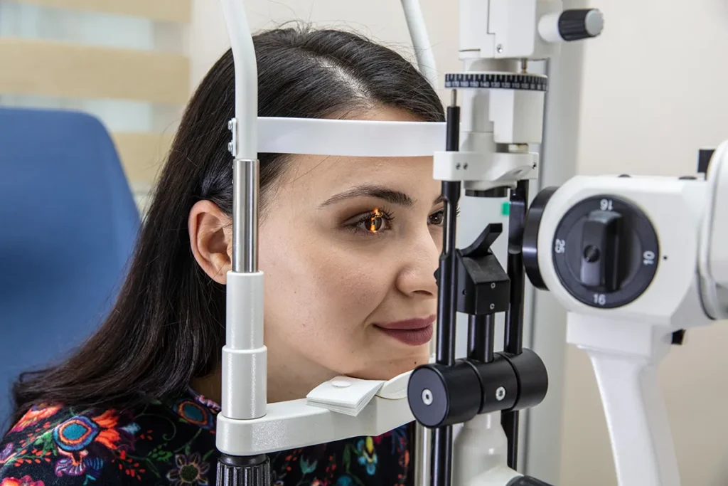 a young woman getting an annual eye exam at the eye doctor's
