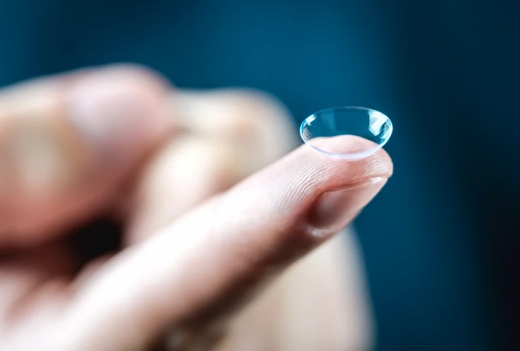 closeup of contact lens on fingertip
